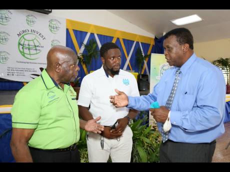 Jeremiah Johnson (right), an overseas investor eyeing opportunities in agriculture, in discussion with Dr Al Powell (left), CEO of the Agro-Investment Corporation, and Calvin Weise, principal/director of the Ebony Park HEART Academy, at a ceremonial handov