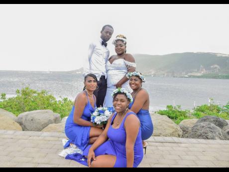 The Blakes are joined in photo by (from left) maid of honour, Cadine Sinclair, and bridesmaids Tejana Ashman and Cathtonia Betty all dressed in royal blue.