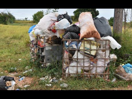 In this June 2022 photo, the main road from Junction to Treasure Beach in St Elizabeth is seen littered with piles of garbage. 