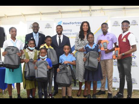 Back row, from left: Oral Heaven, president of the Montego Bay Chamber of Commerce and Industry; Montego Bay Deputy Mayor Richard Vernon; and Verona Carter, vice-president of New Fortress Energy, stand together for a group shot with several St James-based 