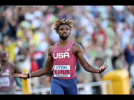 Noah Lyles opens his arms after completing a famous 200-metre title defence at the World Athletics Championships in Eugene, Oregon.