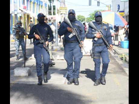 Soldiers and police patrol Market Street in Montego Bay on Monday as part of a 14-day public-order clampdown in collaboration with several government agencies.