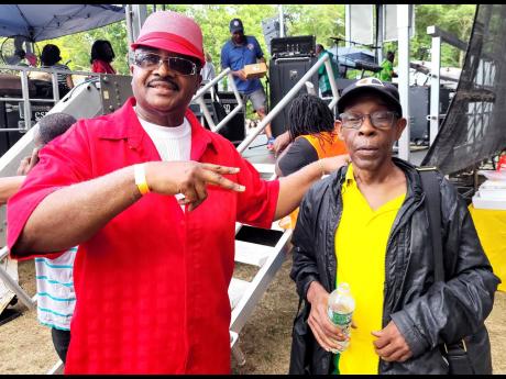 Veteran R&B singer, Stuart Morgan (left) and Grub Cooper, lead singer of Fab 5 band, hang out together at the Tri-State Family Funfest in Long island.
