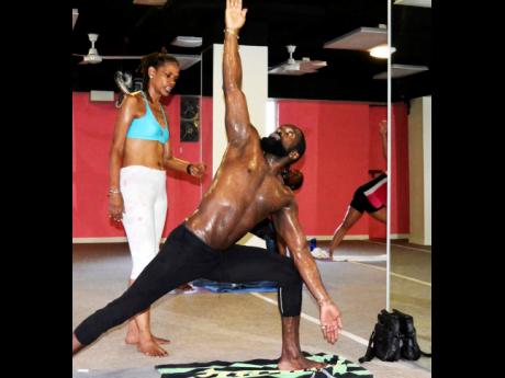 Yolande Lloyd-Small (left) teaching the ‘triangle pose’ at Bikram Yoga Jamaica. 