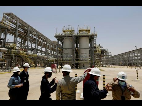 Saudi Aramco engineers and journalists look at the Hawiyah Natural Gas Liquids Recovery Plant in Hawiyah, in the Eastern Province of Saudi Arabia, on June 28, 2021.