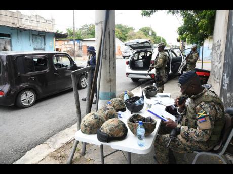 Soldiers on alert at a checkpoint along North Street in downtown Kingston after a state of emergency was declared in the Kingston Western and Kingston Central police divisions on Sunday, June 14, 2020.