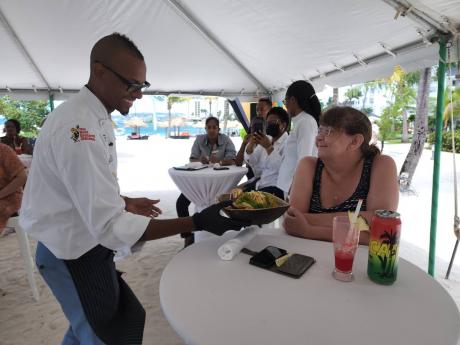 “Take a whiff of the aroma,” Chef Brian Lumley tells this visitor at the AMRJamfest3 at Secrets Resorts in Montego Bay during his cooking class. 