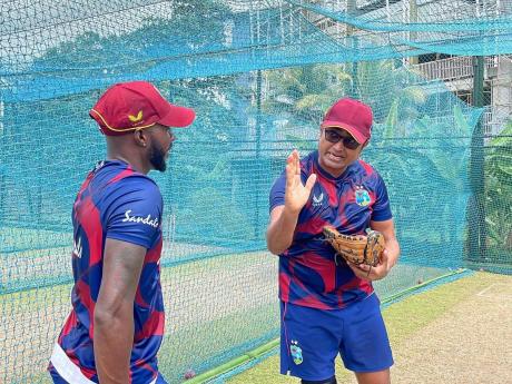 West Indies vice-captain Jermaine Blackwood (left) takes instructions from Monty Desai during a team training session.