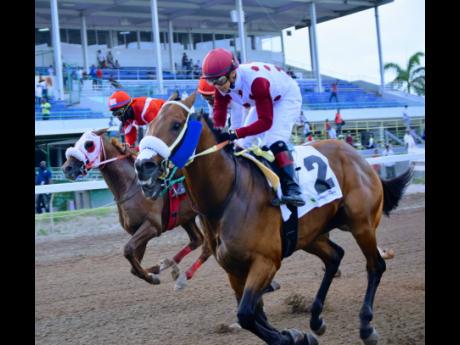 EAGLE ONE (right), ridden by Dick Cardenas, wins the Labour Day Trophy ahead of ANOTHER BU.LET (Robert Halledeen) and the late rushing EXCESSIVE FORCE (Oshane Nugent) over seven furlongs in the eighth-race at Caymanas Park on May 25, 2021.