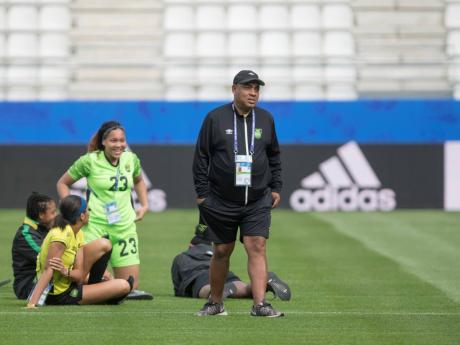 Coach Hue Menzies (foreground), with (from left) Reggae Girlz Chanel Hudson-Marks, Chantelle Swaby and Yazmeen Jamieson at the 2019 FIFA Women’s World Cup in France.