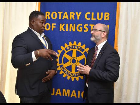 Karsten Johnson (left), president of the Rotary Club of Kingston, is animated as he makes a point to Ian Stein, PAHO/WHO representative to Jamaica, Bermuda, and The Cayman Islands, during a luncheon held at Altamont Court Hotel in New Kingston on Thursday.