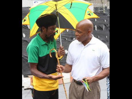 Reggae artiste and community activist Jah Paul interacts with then Brooklyn Borough President Eric Adams, who attended a Jamaica Independence Day flag-raising ceremony in New York on August 6, 2016. Adams, now mayor of New York City, will be the guest spea