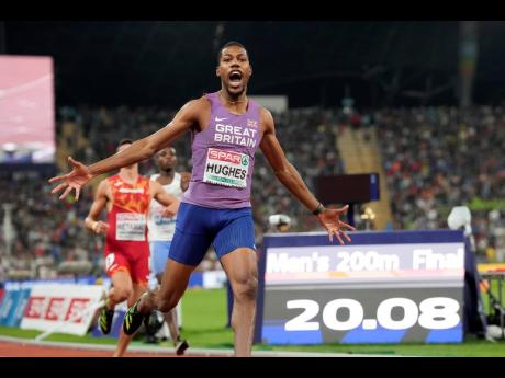 Zharnel Hughes of Great Britain celebrates after winning the gold medal in the men’s 200 metres during the athletics competition at the European Championships in Munich, Germany yesterday.