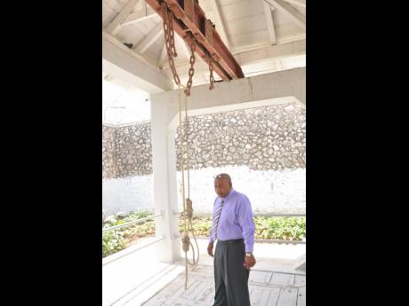 In this 2015 photo, a man looks at a hanging noose at the St Catherine District prison.