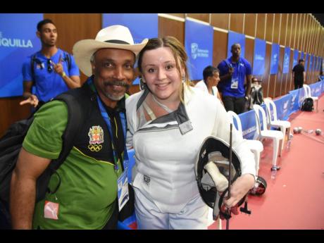 Jamaica’s Caitlin Chang (right) is congratulated by Jamaica Olympic Association president, Christopher Samuda,  after winning a silver medal in the women’s fencing competition at the Central American and Caribbean Games  in 2018.