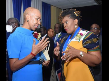 Education Minister Fayval Williams (left), converses with newly-installed Jamaica Teachers’ Association (JTA) President La Sonja Harrison on Monday during the JTA’s 58th annual conference at the Hilton Rose Hall Resort and Spa in Montego Bay, St James.