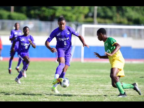 
Christopher Pearson (left) of Kingston College takes on Excelsior High Schools Lennon Green in the Manning Cup quarter-finals, on the way to winning the title last season. 