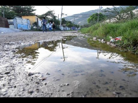 Stagnant water is seen along a roadway in New Haven, western St Andrew, on Saturday.