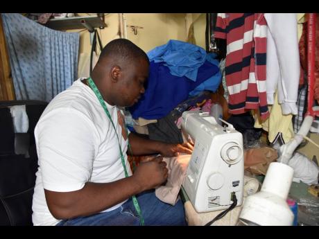 Allan Lewis, a tailor on Brunswick Street, Spanish Town, has had to relearn the art of rapid stitchwork to cope with the crush of mounting orders. It’s a welcome change from the slow business induced by coronavirus restrictions over the last two years. 