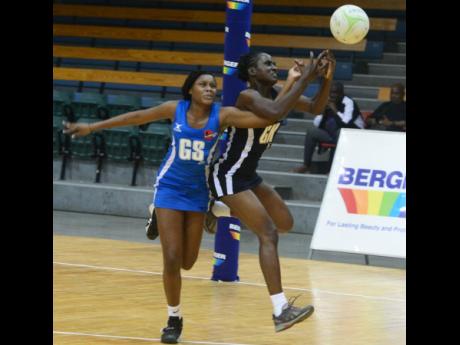 Clarendon Gaters goal-shooter Amanda Pinkey (left) challenges for ball with Manchester Spurs' goal keeper Suthania Scott  during a Berger Elite League netball semi-final match at the National Indoor Sports Centre in 2019.