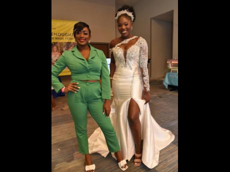 Owner of Luxbrides JA Samantha Grant-Robinson (left) showcases one of her gorgeous gowns worn by her model during the fashion show.