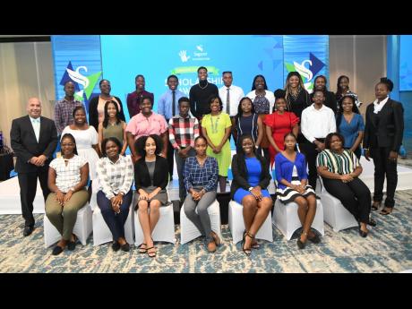 Christopher Zacca (left, second row), president and CEO, Sagicor Group Jamaica; and Chorvelle Johnson (right), Sagicor Bank CEO, pose with Sagicor Foundation Tertiary Scholarship awardees at The Jamaica Pegasus hotel in New Kingston on August 29.