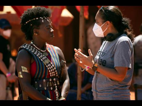 This image released by Sony Pictures shows Viola Davis, left, with director Gina Prince-Bythewood on the set of ‘The Woman King’.