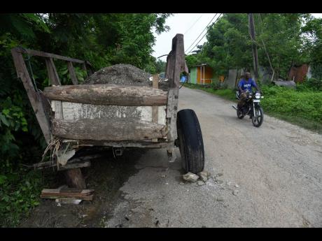 A broken cane cart abandoned along the roadway in Cheswick, St Thomas. Residents say there have been little opportunities for many of them to make a living since the Golden Grove Sugar Factory closed in 2019.