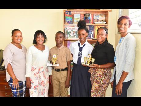 Top students at the Brown’s Hall Primary School, Ihka Brown (third left) and Nastassia Robinson (third right), with their prizes at the school recently. Sharing the moment (from left) are Vice Principal Stacy Nelson; mother of Ihka, Maria Whyte; mother o