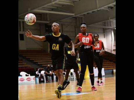Jamaica’s male netball captain Kurt Dale (left) competing in an exhibition match against Trinidad and Tobago’s women’s team  at the National Indoor Sports Centre last year.