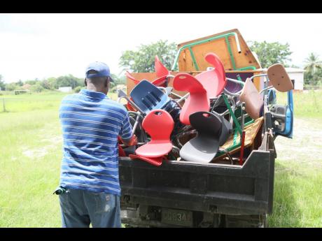 A workman loads furniture on to a truck for the relocation of operations of the Goshen Early Childhood Institution to the grade one block of the Goshen Primary School in St Elizabeth on Thursday.