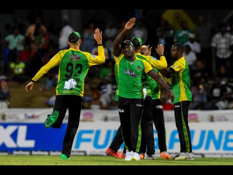  Captain Rovman Powell (second left) celebrates the fall of a wicket with his Jamaica Tallawahs teammates during Wednesday’s match against the against St Kitts and Nevis Patriots at Warner Park Sporting Complex in Basseterre, St Kitts.