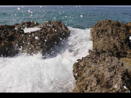 Waves kiss the rocks at the edge of Tingalay's Retreat. 