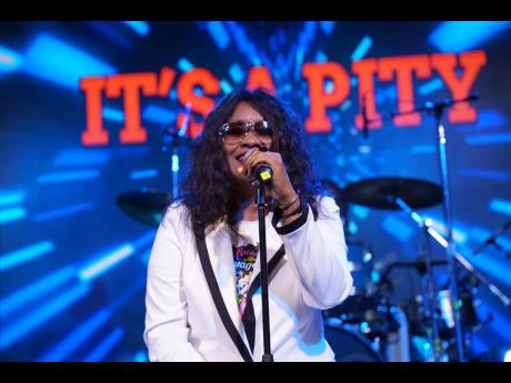Tanya Stephens in signature shades while on stage delivering her hit ‘It’s a Pity’ at her album Some Kind of Madness launch.