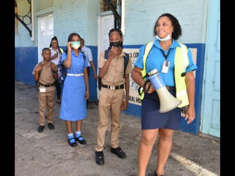 With bullhorn in hand, Shaunice Bignall-Young met the arriving train at the Spanish Town Railway Station on Monday to marshal the students to their connecting shuttles en route to school, but the anticipated ridership did not materialise.