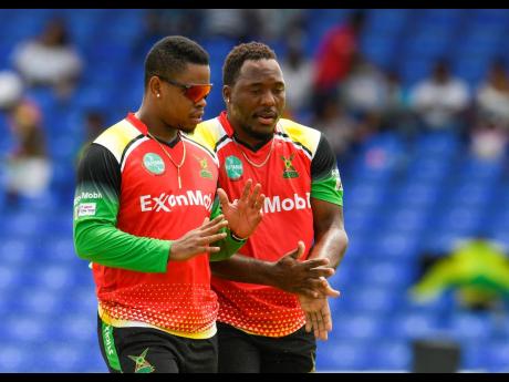 Jamaican Odean Smith (right) discussing tactics with Guyana Amazon Warriors captain Shimron Hetmyer during  during the men’s 2022 Hero Caribbean Premier League between Jamaica Tallawahs and Guyana Amazon Warriors at Warner Park Sporting Complex on Septem