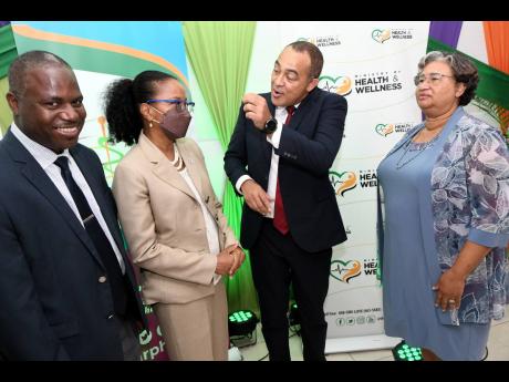 Minister of Health and Wellness Dr Christopher Tufton (second right) in discussion with (from left): Professor Trevor Ferguson, director of the Epidemiology Research Unit; Dr Karen Webster-Kerr, national epidemiologist, Ministry of Health and Wellness; and