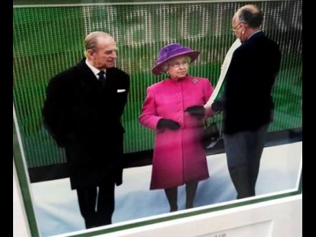A photo of Mike Fennell (right) with Queen Elizabeth II and husband Prince Philip.