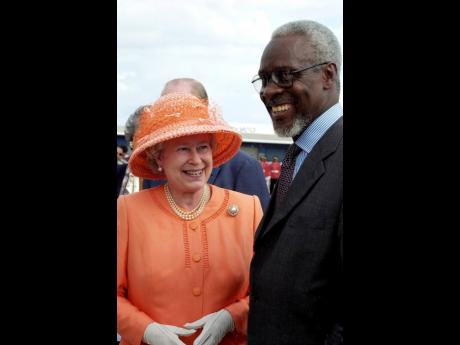 Queen Elizabeth II (left) and then Prime Minister P.J. Patterson share broad smiles in 2002.