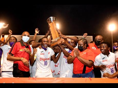 Members of Kingston College (KC) celebrate with the trophy after winning the Manning Cup title at the end of last season. KC will open today against archrivals Calabar.
