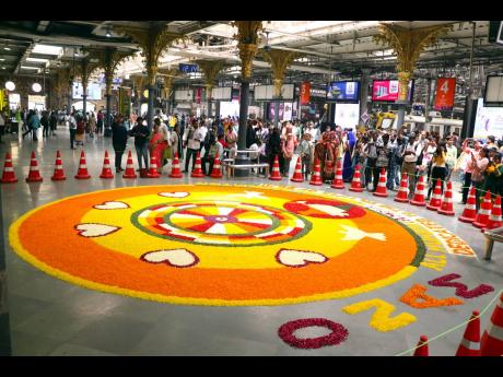 A floral decoration named pookkalam made on the occasion of Onam festival by Jojo Thomas and group, in memory of victims of 26/11 terror attacks, at Chhatrapati Shivaji Maharaj Terminus in Mumbai, India.