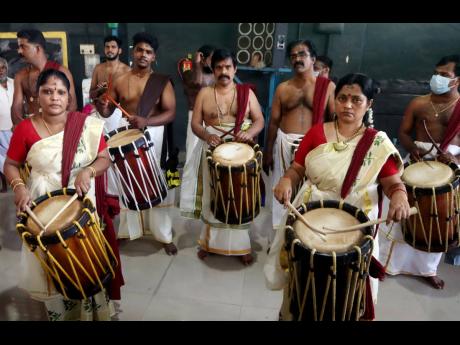 A group of people play traditional drums on the occasion of Onam in Chennai, India.