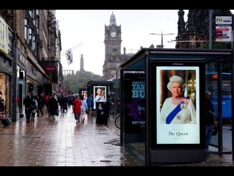 Tributes to Queen Elizabeth II are seen on bus stops on Princes Street in Edinburgh. 