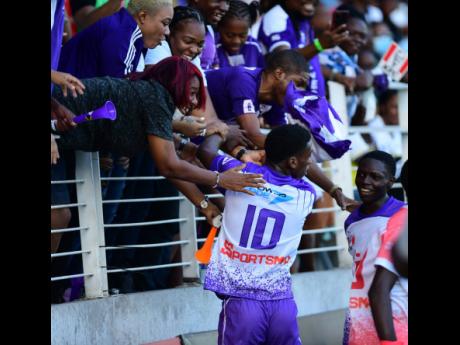 
Kingston College’s Dujuan Richards (No. 10) celebrates scoring with his school’s supporters in the North Stand during the Inter-Secondary Schools’ Sports Association (ISSA)/Digicel schoolboy football fixture at Sabina Park yesterday. KC won 5-1.