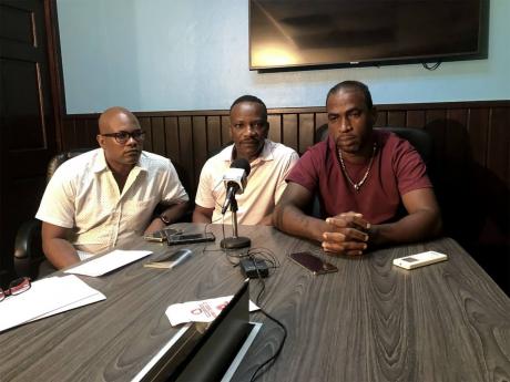 Adrian Laing, father of the lone survivor of a fire that claimed the lives of three brothers, pleads for financial help for burn-care treatment for his daughter. Beside him are Robert White (centre), managing director of Sanmerna Paper Products Limited and