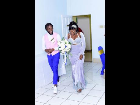 As the couple made their first entrance as husband and wife into the reception, guests were happy to see that the groom had ditched his jacket and the bride had changed her dress. It was a sign that it was time to party.