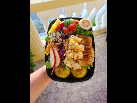 A tasty dish containing grilled chicken and grilled lobster salad, inclusive of fruits and vegetables, with sweet mashed potato on the side. 