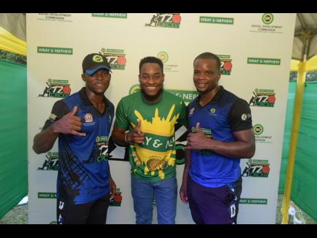 Boscobel team captain Orlando Lyons (left) and Man of the Match Alwyn William (right) capture their winning moment with Pavel Smith, marketing manager at J. Wray & Nephew Ltd, at the SDC/Wray & Nephew cricket finals at Port Rhoades Sports Club, Discovery B