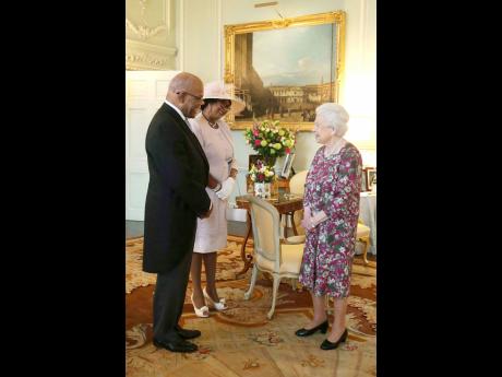 Former Jamaican High Commissioner Mr Seth George Ramocan and his wife Dr Lola Ramocan exchange pleasantries with The Queen when he presented his credentials at Buckingham Palace in 2017.