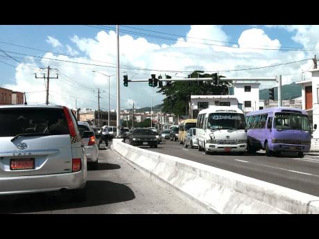 Coaster buses impede traffic along Constant Spring Road, St Andrew. Contributed